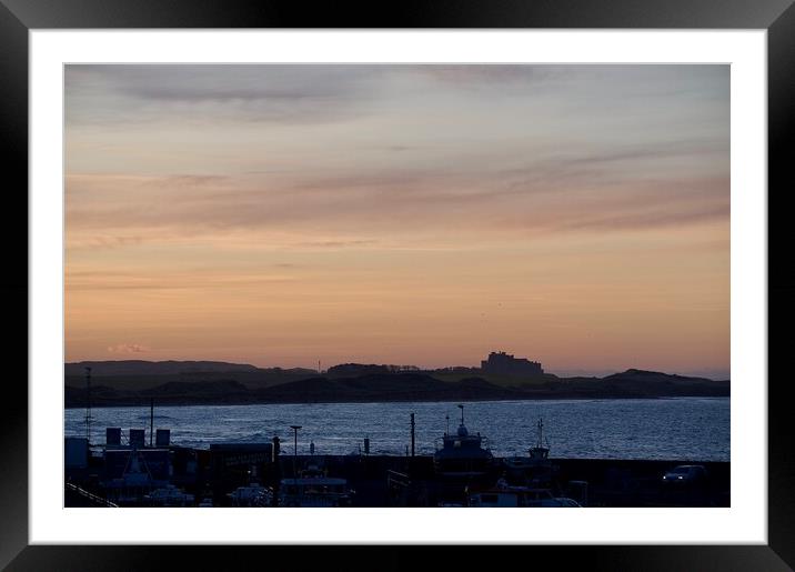 Sunset at Seahouses harbour bamburgh castle in the distance Framed Mounted Print by Helen Reid