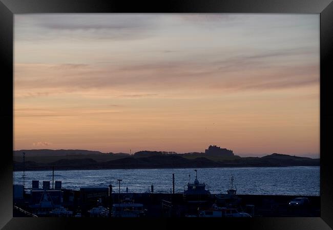 Sunset at Seahouses harbour bamburgh castle in the distance Framed Print by Helen Reid