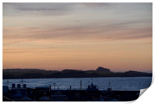 Sunset at Seahouses harbour bamburgh castle in the distance Print by Helen Reid