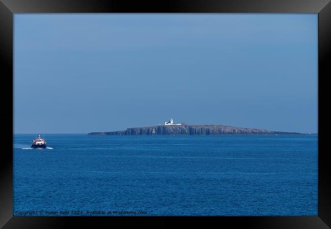 Northhumberland Farne lighthouse with a passenger boat Framed Print by Helen Reid