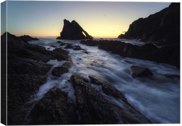 Ethereal Sunrise at Bow Fiddle Rock Canvas Print by Anthony McGeever