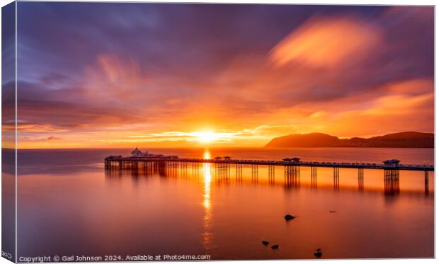 Sunrise over llandudno Pier with the tide in  Canvas Print by Gail Johnson