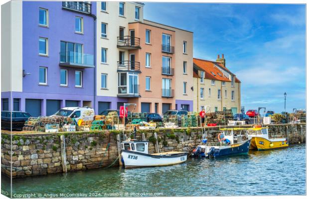 Colourful quayside buildings on St Andrews harbour Canvas Print by Angus McComiskey