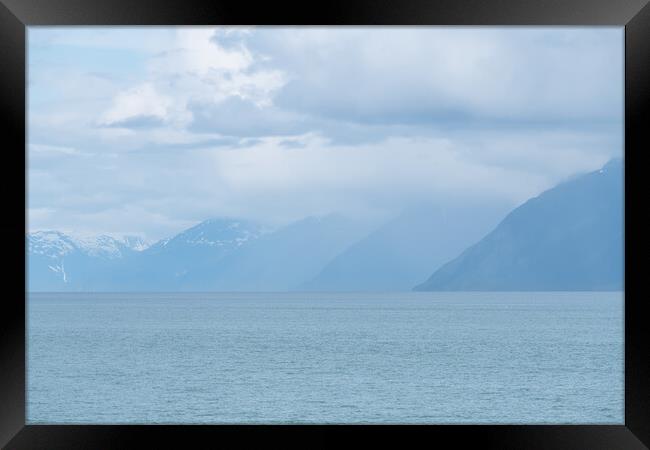 Distance Mountains in mist in Prince William Sound, Alaska, USA Framed Print by Dave Collins