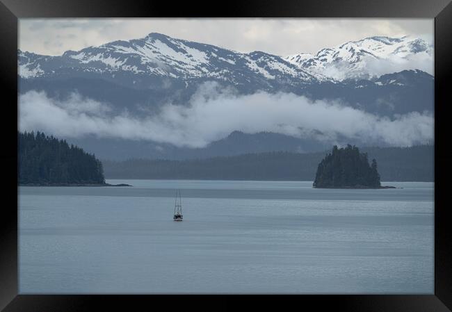 Commercial fishing boat  in Frederick Sound near Petersburg with clouds around the mountains beyond, Alaska, USA Framed Print by Dave Collins