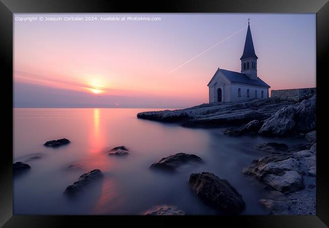 A church stands tall on a rocky shore next to the ocean, with the sunset on the horizon. Framed Print by Joaquin Corbalan