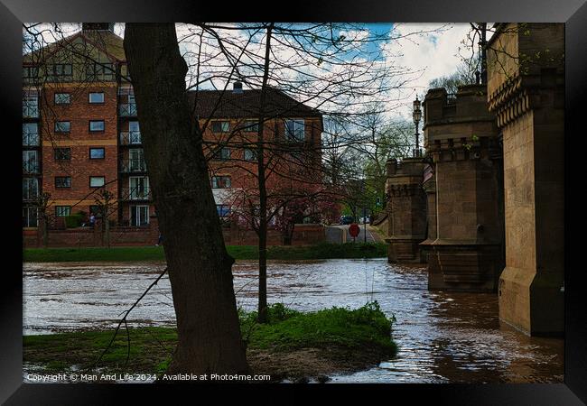 Urban riverside scene with swollen river waters, lush greenery, and a backdrop of modern residential buildings, showcasing the contrast between nature and urban development in York, North Yorkshire, England. Framed Print by Man And Life