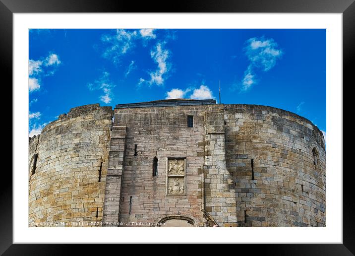 Medieval stone fortress against a vibrant blue sky with fluffy clouds, showcasing ancient architecture and historical military construction in York, North Yorkshire, England. Framed Mounted Print by Man And Life