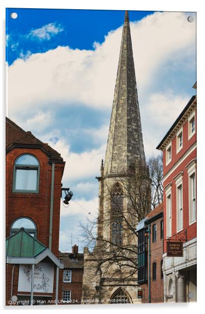 Vertical shot of an ancient church spire reaching into a blue sky with clouds, flanked by traditional brick buildings, showcasing architectural contrast and historical cityscape in York, North Yorkshire, England. Acrylic by Man And Life