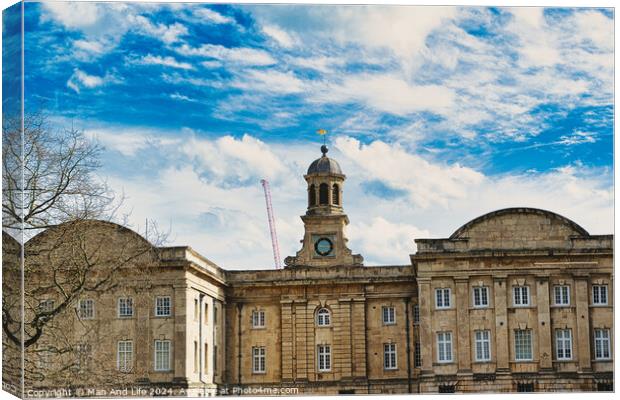 Historic stone building with a central clock tower under a blue sky with fluffy clouds, featuring classic architecture and a construction crane in the background in York, North Yorkshire, England. Canvas Print by Man And Life