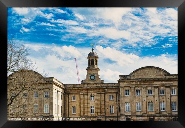 Historic stone building with a central clock tower under a blue sky with fluffy clouds, featuring classic architecture and a construction crane in the background in York, North Yorkshire, England. Framed Print by Man And Life