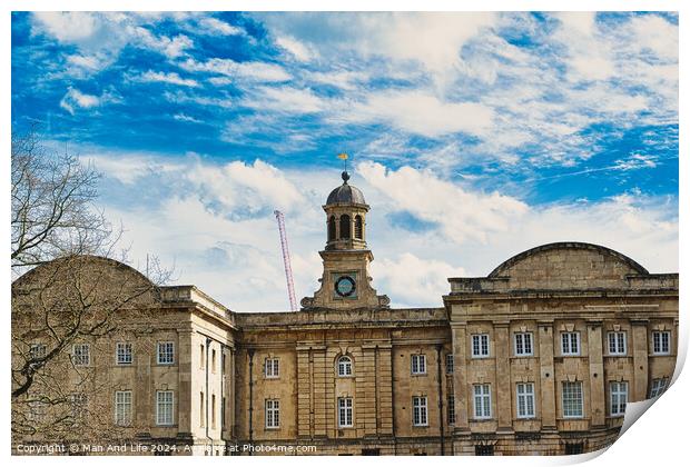 Historic stone building with a central clock tower under a blue sky with fluffy clouds, featuring classic architecture and a construction crane in the background in York, North Yorkshire, England. Print by Man And Life
