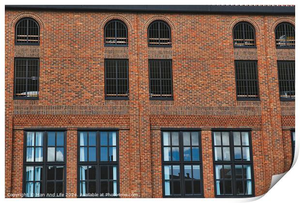 Facade of a vintage brick building with rows of windows reflecting the sky, showcasing industrial architecture in York, North Yorkshire, England. Print by Man And Life