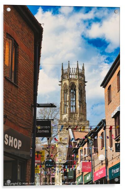 Quaint urban street with festive bunting leading to a historic church tower under a blue sky with fluffy clouds in York, North Yorkshire, England. Acrylic by Man And Life