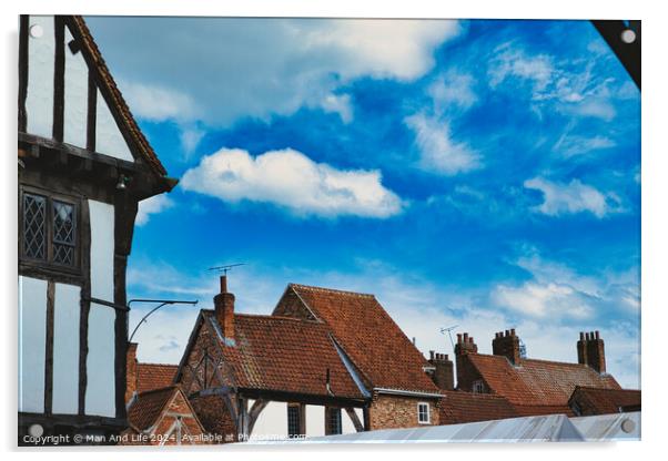 Quaint European village with traditional half-timbered houses and terracotta rooftops under a vibrant blue sky with fluffy clouds in York, North Yorkshire, England. Acrylic by Man And Life