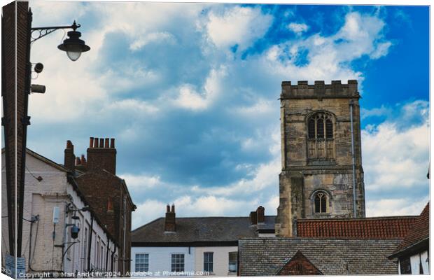 Quaint European street with historic buildings and a prominent church tower under a dramatic sky with fluffy clouds in York, North Yorkshire, England. Canvas Print by Man And Life