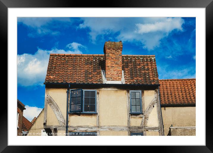 Old European house with half-timbered walls and a red tiled roof against a blue sky with clouds. Vintage architecture with visible wear and character in York, North Yorkshire, England. Framed Mounted Print by Man And Life
