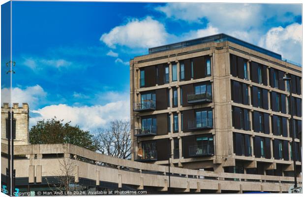 Modern urban apartment building with balconies against a blue sky with fluffy clouds. Architectural exterior of residential structure in a city setting in York, North Yorkshire, England. Canvas Print by Man And Life