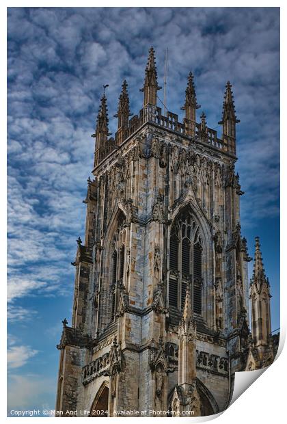 Gothic cathedral tower against a dramatic cloudy sky, showcasing intricate architectural details and spires, ideal for historical or religious themes in York, North Yorkshire, England. Print by Man And Life