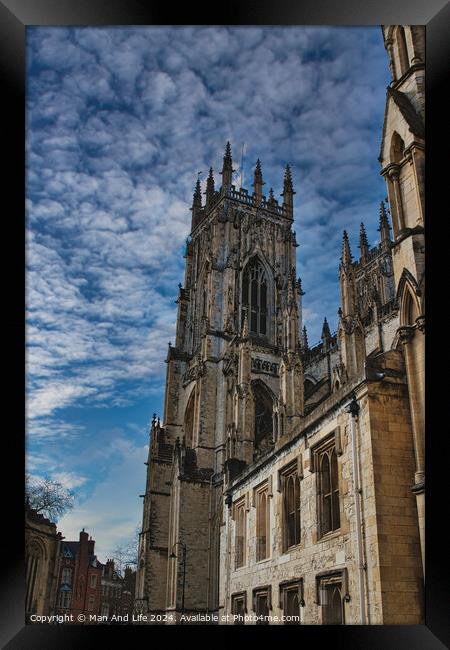 Gothic cathedral against a dramatic sky with fluffy clouds, showcasing intricate architecture and historical grandeur, ideal for travel and cultural themes in York, North Yorkshire, England. Framed Print by Man And Life