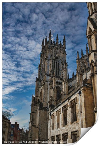 Gothic cathedral against a dramatic sky with fluffy clouds, showcasing intricate architecture and historical grandeur, ideal for travel and cultural themes in York, North Yorkshire, England. Print by Man And Life