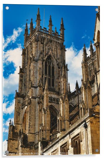 Gothic cathedral tower against a blue sky with clouds, showcasing intricate architectural details and flying buttresses in York, North Yorkshire, England. Acrylic by Man And Life
