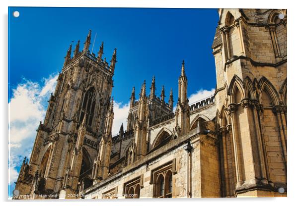 Majestic Gothic cathedral against a blue sky with clouds, showcasing intricate architecture and historical religious significance in York, North Yorkshire, England. Acrylic by Man And Life