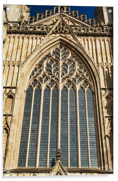Gothic architecture detail of a cathedral window with intricate tracery and stained glass, set against a clear blue sky in York, North Yorkshire, England. Acrylic by Man And Life