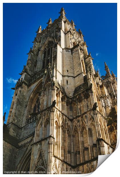 Gothic cathedral facade with intricate architecture against a clear blue sky, showcasing historical religious building's exterior details in York, North Yorkshire, England. Print by Man And Life