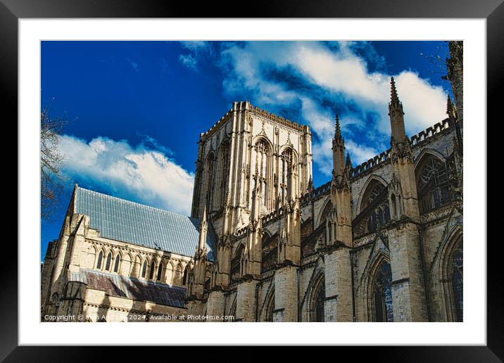 Majestic Gothic cathedral against a blue sky with fluffy clouds, showcasing intricate architecture and historical grandeur in York, North Yorkshire, England. Framed Mounted Print by Man And Life