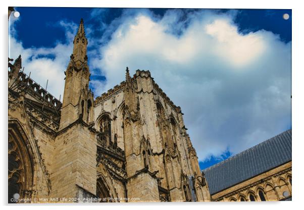Majestic gothic cathedral facade against a dramatic sky with fluffy clouds, showcasing intricate architectural details and historical religious significance in York, North Yorkshire, England. Acrylic by Man And Life