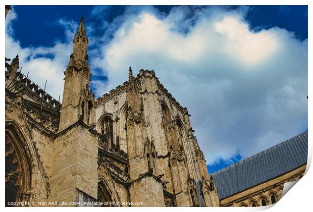 Majestic gothic cathedral facade against a dramatic sky with fluffy clouds, showcasing intricate architectural details and historical religious significance in York, North Yorkshire, England. Print by Man And Life