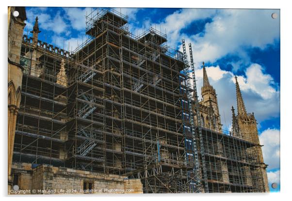 Gothic cathedral undergoing restoration, with extensive scaffolding against a dramatic cloudy sky in York, North Yorkshire, England. Acrylic by Man And Life