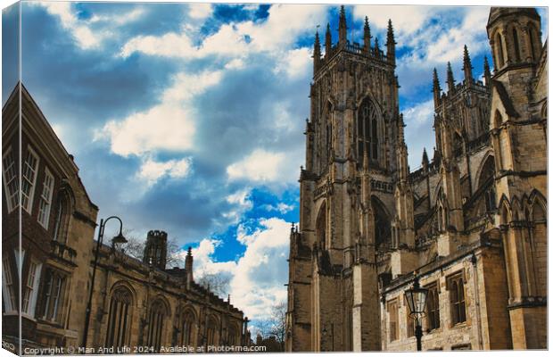 Dramatic sky over a majestic Gothic cathedral with intricate architecture, flanked by historic buildings, showcasing a blend of heritage and natural beauty in York, North Yorkshire, England. Canvas Print by Man And Life