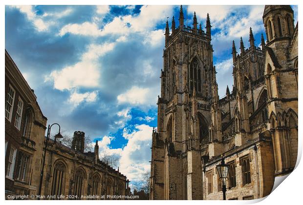 Dramatic sky over a majestic Gothic cathedral with intricate architecture, flanked by historic buildings, showcasing a blend of heritage and natural beauty in York, North Yorkshire, England. Print by Man And Life