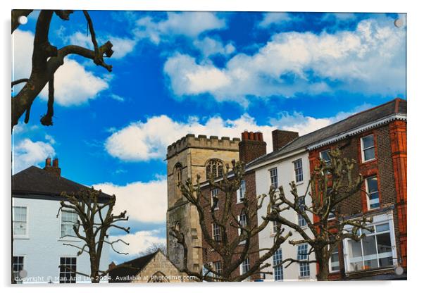 Quaint urban scene with historic stone tower, traditional buildings, and bare tree branches against a vibrant blue sky with fluffy white clouds in York, North Yorkshire, England. Acrylic by Man And Life