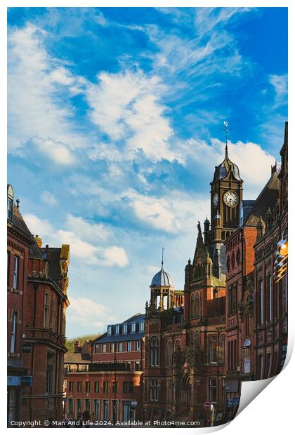 Vintage European architecture with a prominent clock tower under a vibrant blue sky with wispy clouds, capturing the essence of historic urban charm in York, North Yorkshire, England. Print by Man And Life