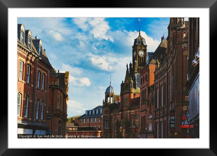 Historic European architecture with a clock tower under a blue sky with clouds. Old buildings with intricate details in a cityscape in York, North Yorkshire, England. Framed Mounted Print by Man And Life