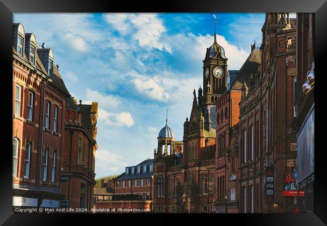 Historic European architecture with a clock tower under a blue sky with clouds. Old buildings with intricate details in a cityscape in York, North Yorkshire, England. Framed Print by Man And Life