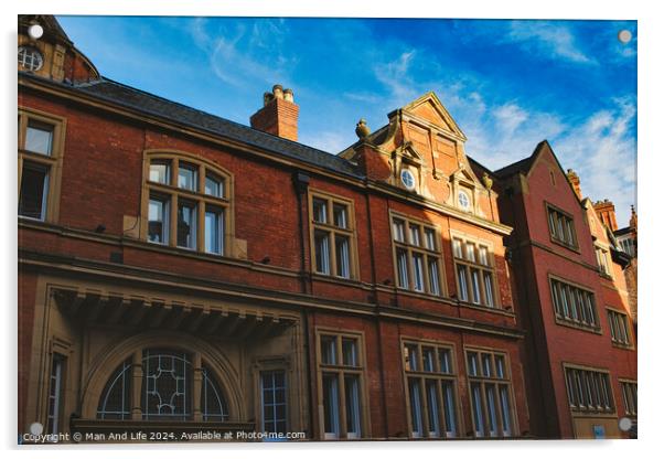 Traditional red brick building with ornate windows under a clear blue sky, showcasing classic architectural details and warm sunlight casting shadows in York, North Yorkshire, England. Acrylic by Man And Life