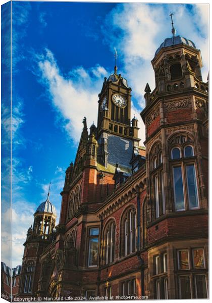 Gothic architecture of a historic building with a prominent clock tower against a blue sky with clouds in York, North Yorkshire, England. Canvas Print by Man And Life