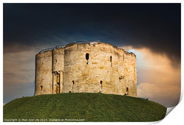 Dramatic sky over an ancient stone fortress atop a lush green hill, symbolizing historical strength and medieval architecture in York, North Yorkshire, England. Print by Man And Life
