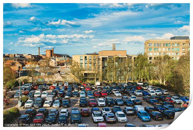 Urban parking lot filled with cars on a sunny day, with city buildings in the background and a clear blue sky overhead in York, North Yorkshire, England. Print by Man And Life