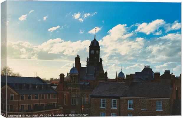 Vintage European architecture with a clock tower against a backdrop of a dramatic sky with fluffy clouds, capturing the essence of a historic town at sunset in York, North Yorkshire, England. Canvas Print by Man And Life