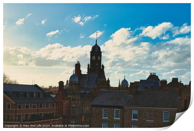 Vintage European architecture with a clock tower against a backdrop of a dramatic sky with fluffy clouds, capturing the essence of a historic town at sunset in York, North Yorkshire, England. Print by Man And Life