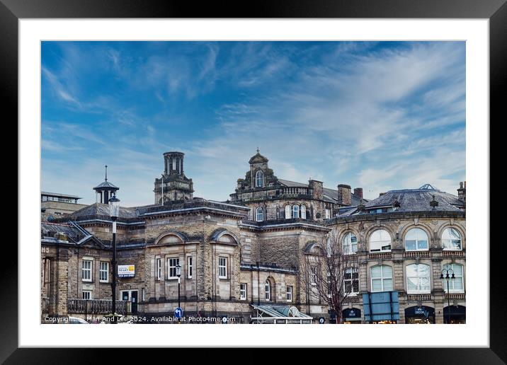 Classic European architecture under a dynamic sky with wispy clouds, showcasing historic buildings with intricate facades in an urban setting in Harrogate, North Yorkshire. Framed Mounted Print by Man And Life