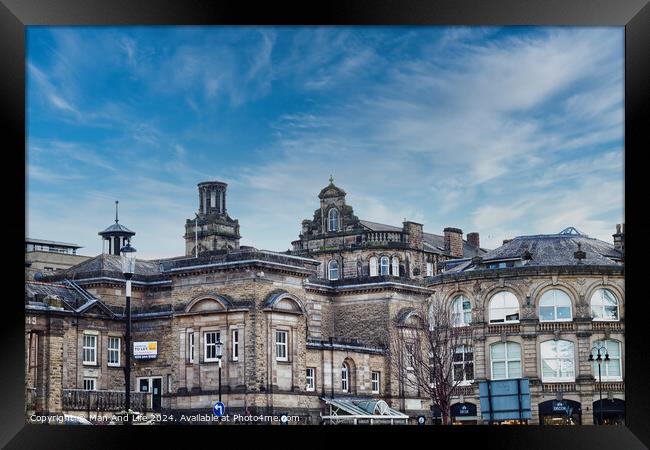 Classic European architecture under a dynamic sky with wispy clouds, showcasing historic buildings with intricate facades in an urban setting in Harrogate, North Yorkshire. Framed Print by Man And Life