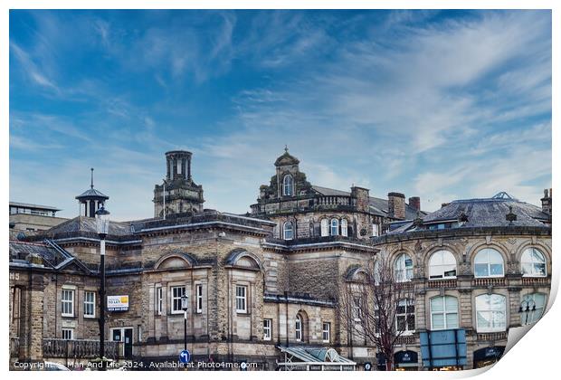 Classic European architecture under a dynamic sky with wispy clouds, showcasing historic buildings with intricate facades in an urban setting in Harrogate, North Yorkshire. Print by Man And Life