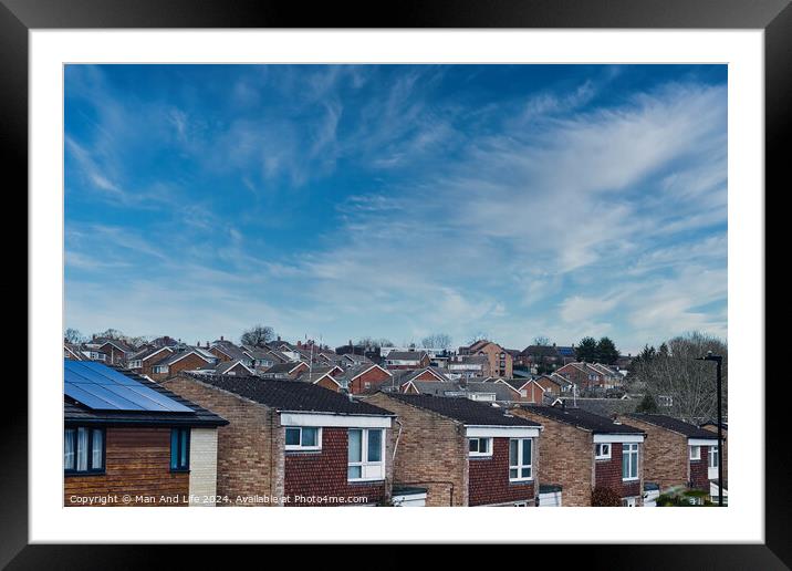 Suburban skyline with rows of houses and solar panels on a roof under a blue sky with wispy clouds in Harrogate, North Yorkshire. Framed Mounted Print by Man And Life