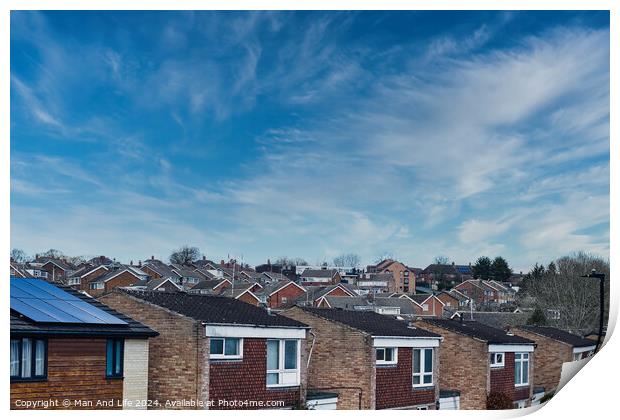 Suburban skyline with rows of houses and solar panels on a roof under a blue sky with wispy clouds in Harrogate, North Yorkshire. Print by Man And Life